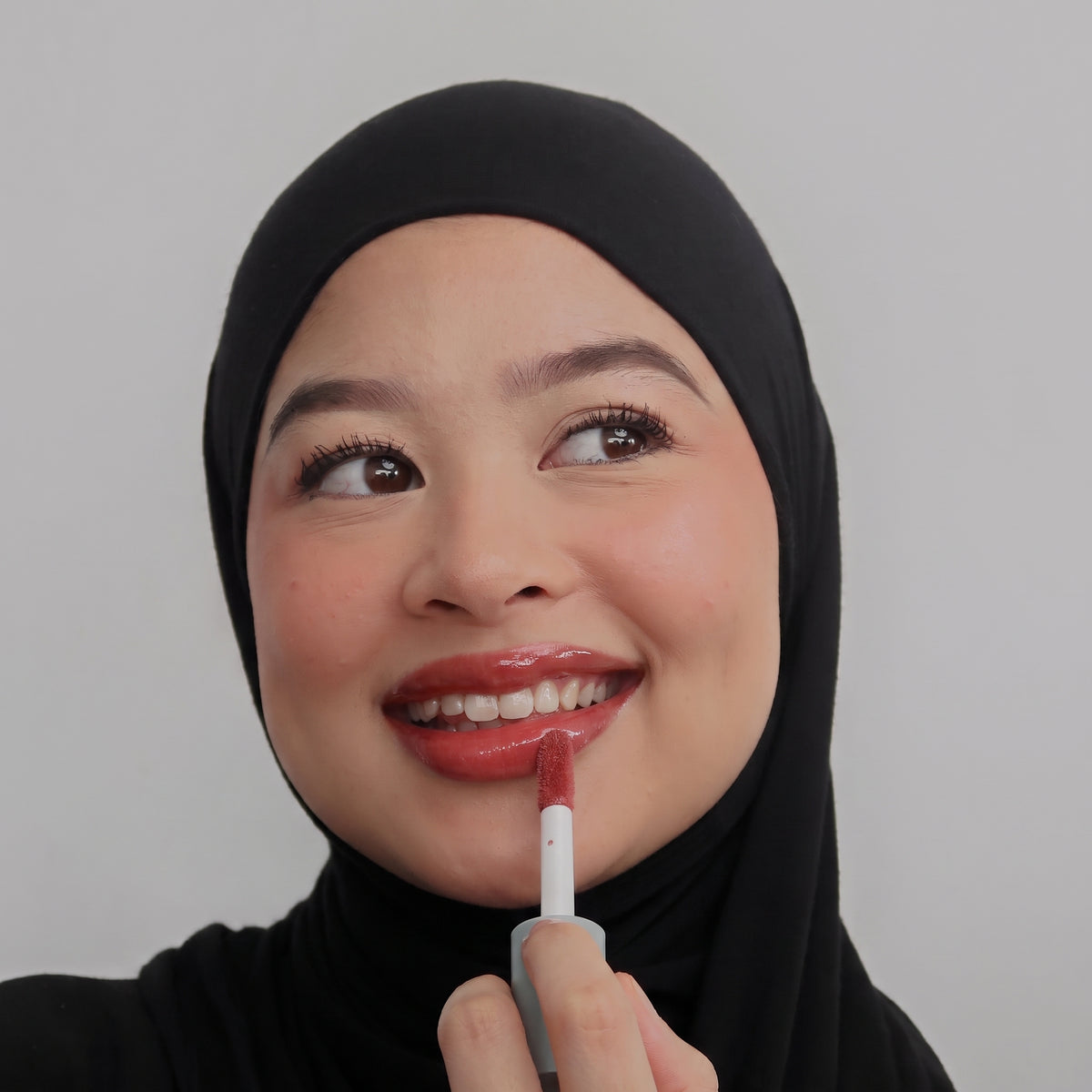 Peptide Glo Lip Oil in Cherry Jam worn on model (3 of 4)