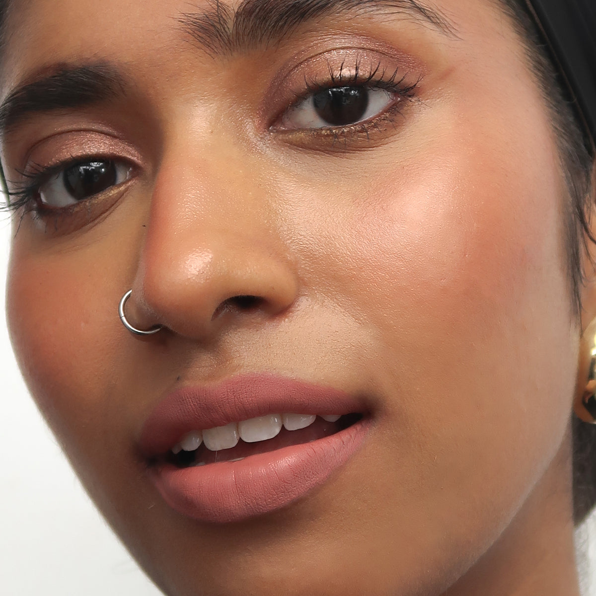 Peptide Hydra-Matte Lipstick in Love Letter on tan skin