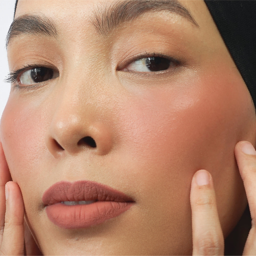 Hyaluronic Liquid Blush in Left On Red on medium skin