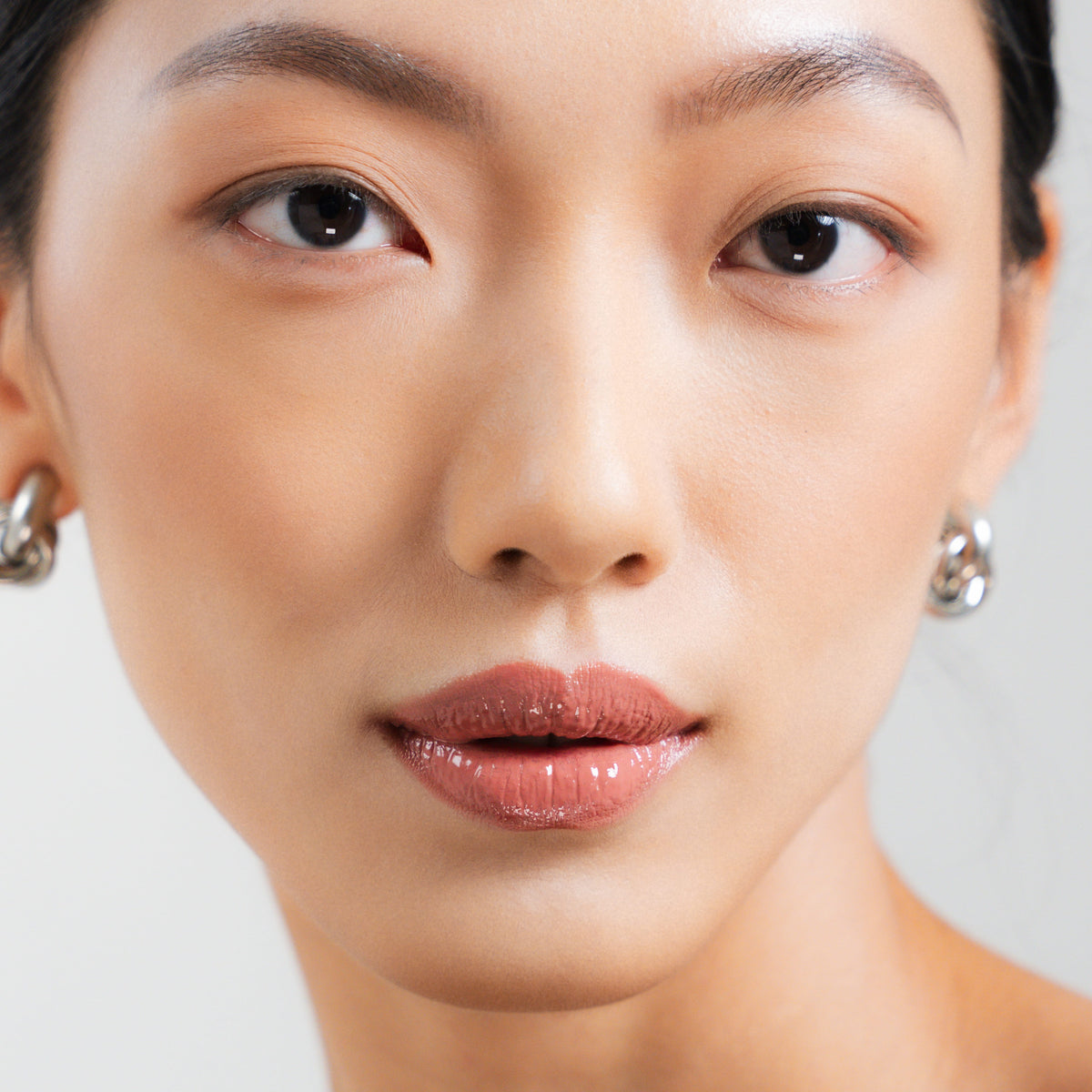 Peptide Glo Lip Glaze in Mellow on fair skin