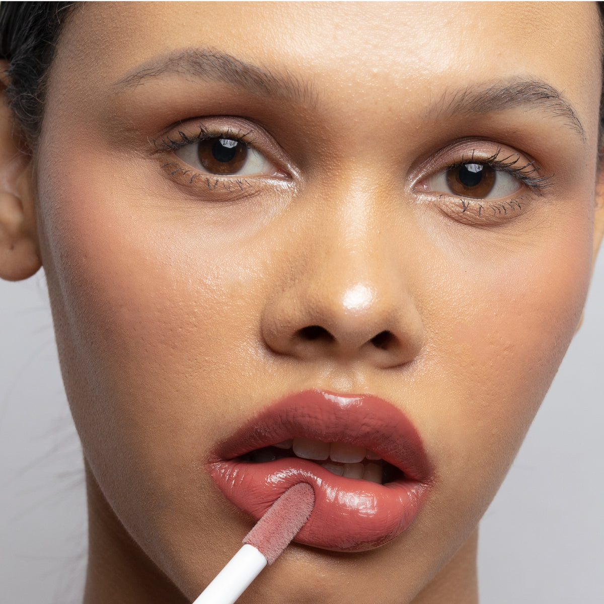 Peptide Glo Lip Glaze in Cameo on medium skin