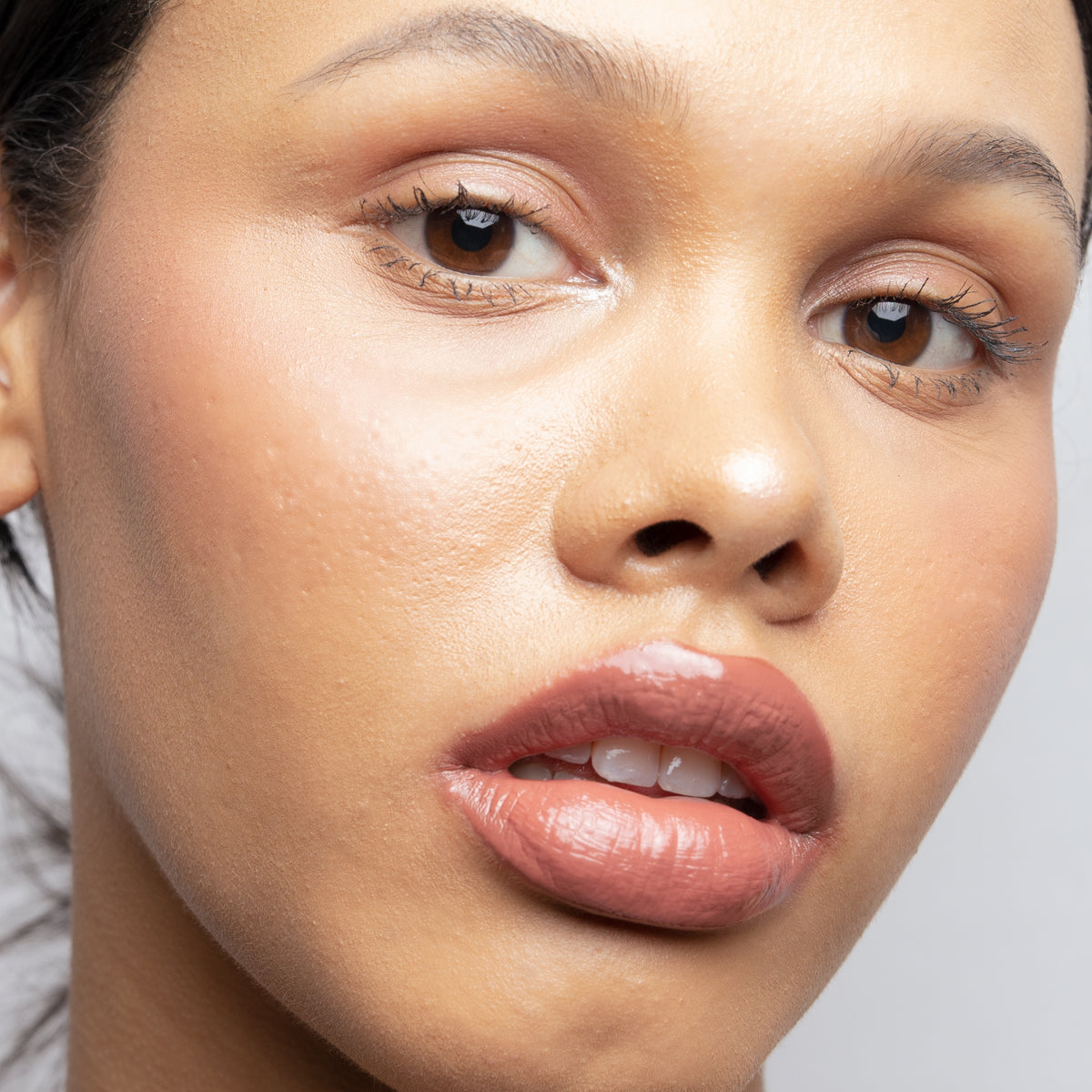 Peptide Glo Lip Glaze in Solace on medium skin