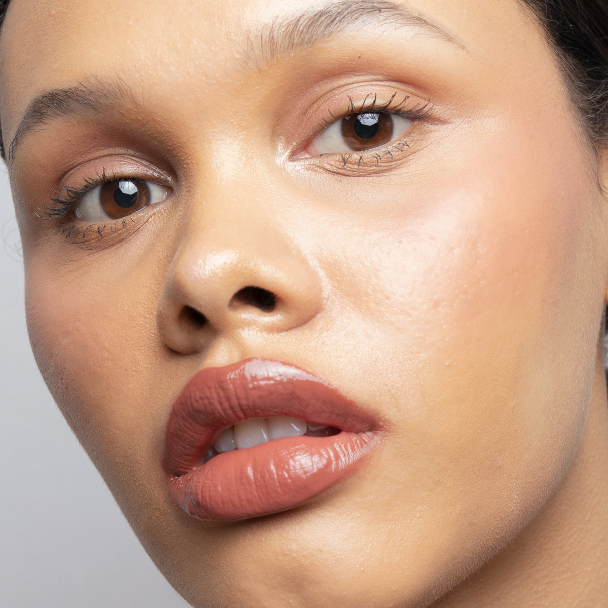 Peptide Glo Lip Glaze in Veil on medium skin
