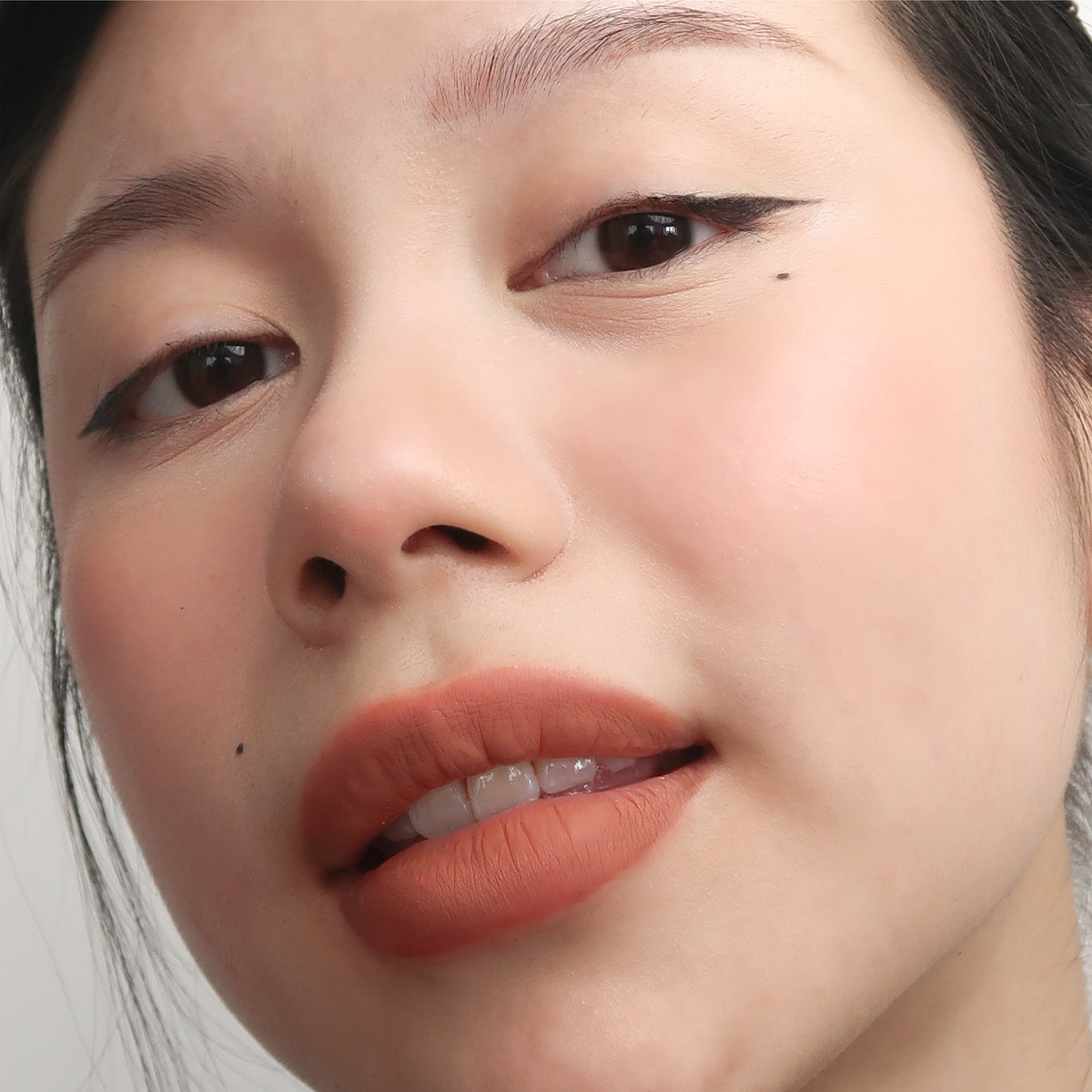 Peptide Hydra-Matte Lipstick in Cinnamon on fair skin