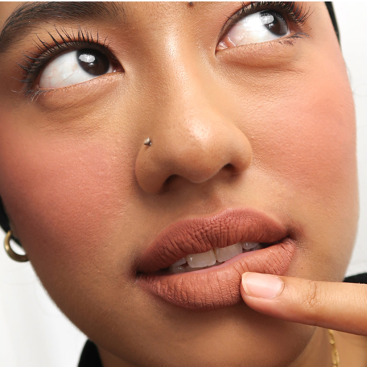 Peptide Hydra-Matte Lipstick in Cinnamon on medium skin