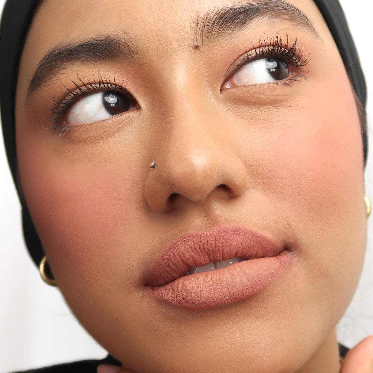 Peptide Hydra-Matte Lipstick in Cookie on medium skin