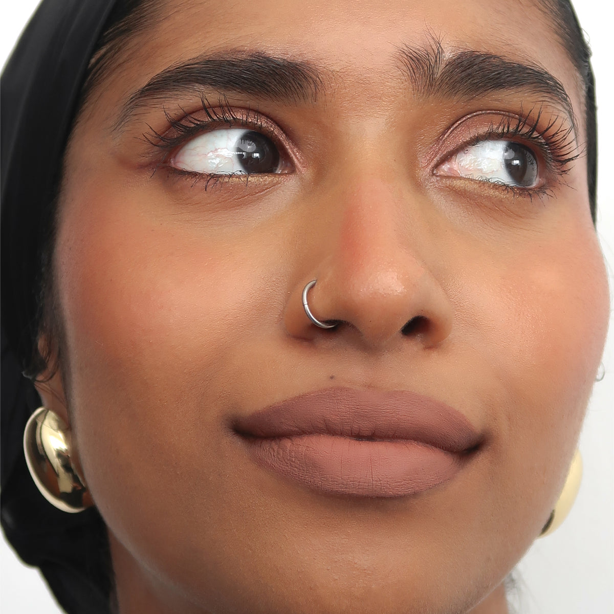 Peptide Hydra-Matte Lipstick in Cookie on tan skin