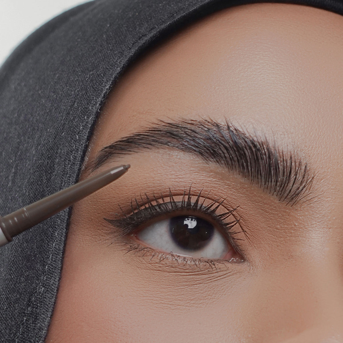 Soft Trace Brow Pencil in Brown on tan skin