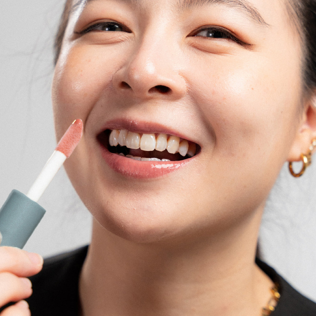 Peptide Glo Lip Oil in Strawberry Milkshake worn on model (1 of 4)