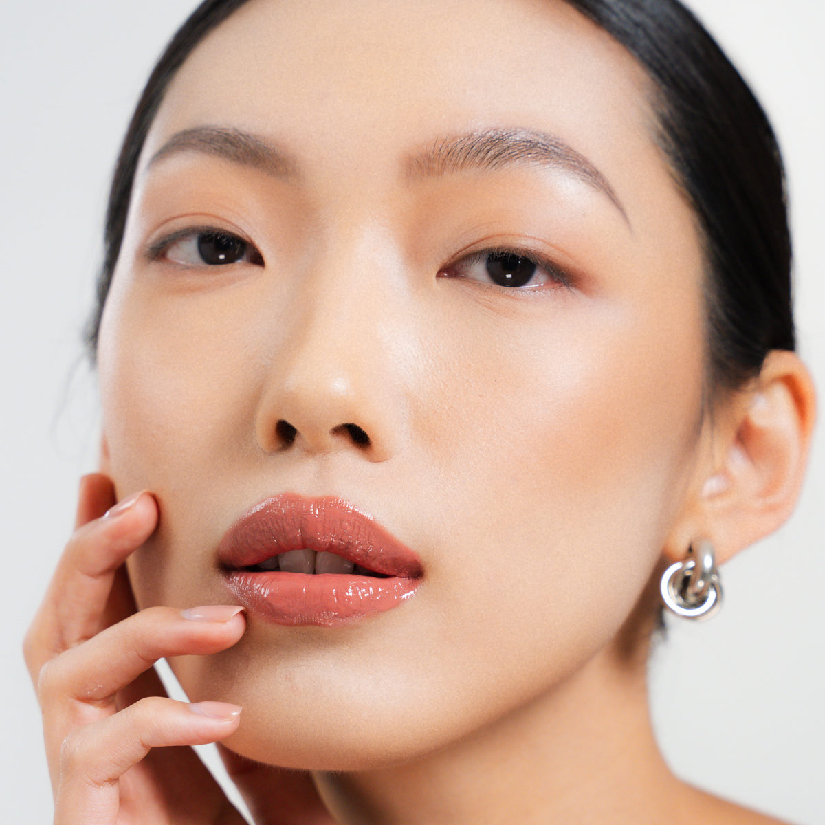 Peptide Glo Lip Glaze in Sway on fair skin